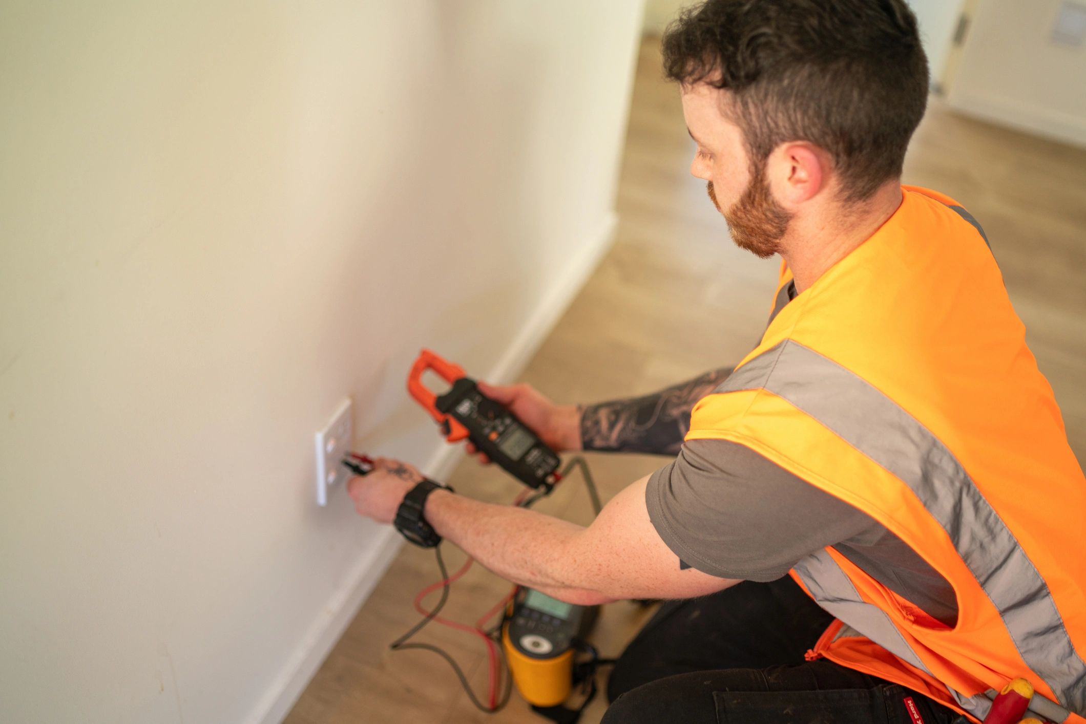 Technician using a volt meter for electrical testing